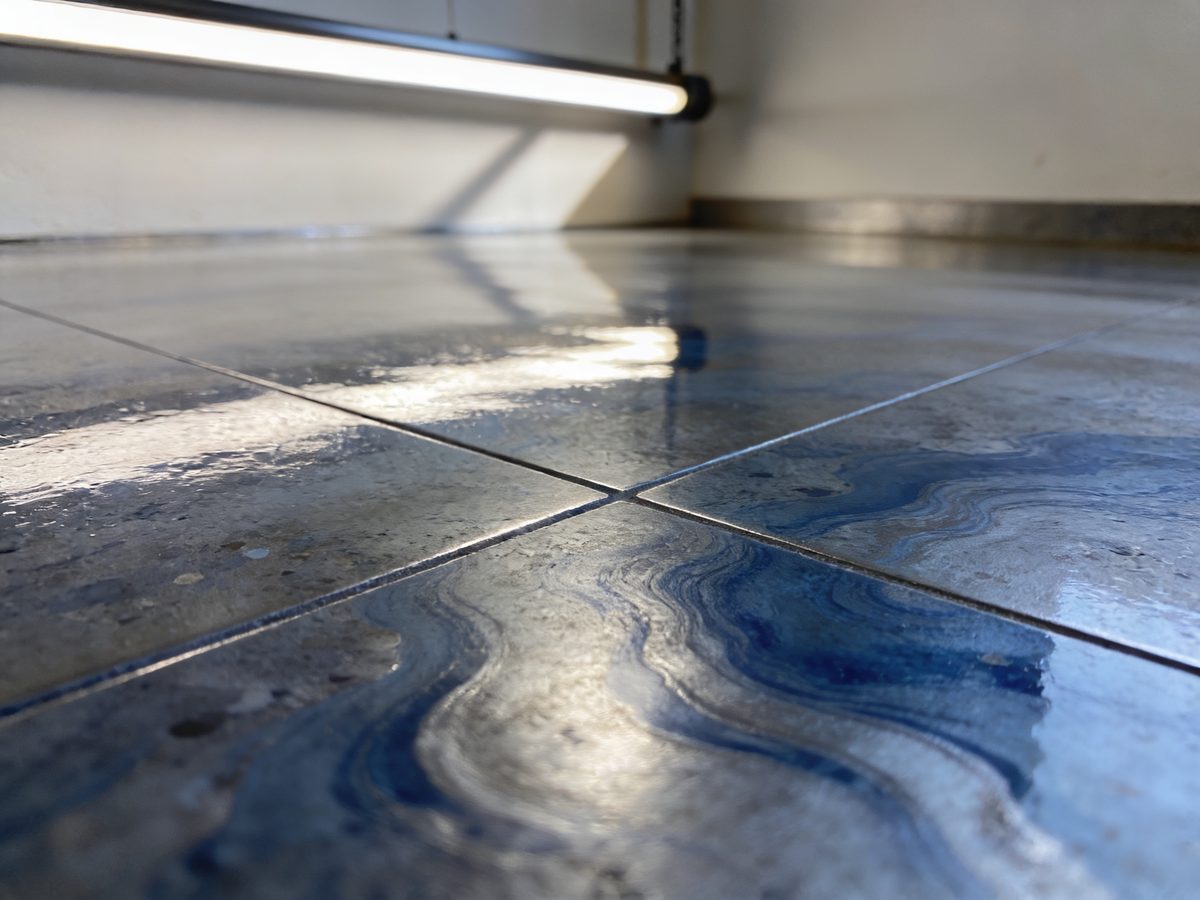 A metallic epoxy floor in slate blue and silver pigments under a high-gloss topcoat